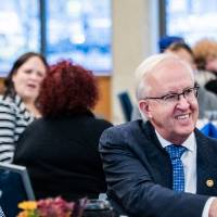 A guest shaking another guest's hand.